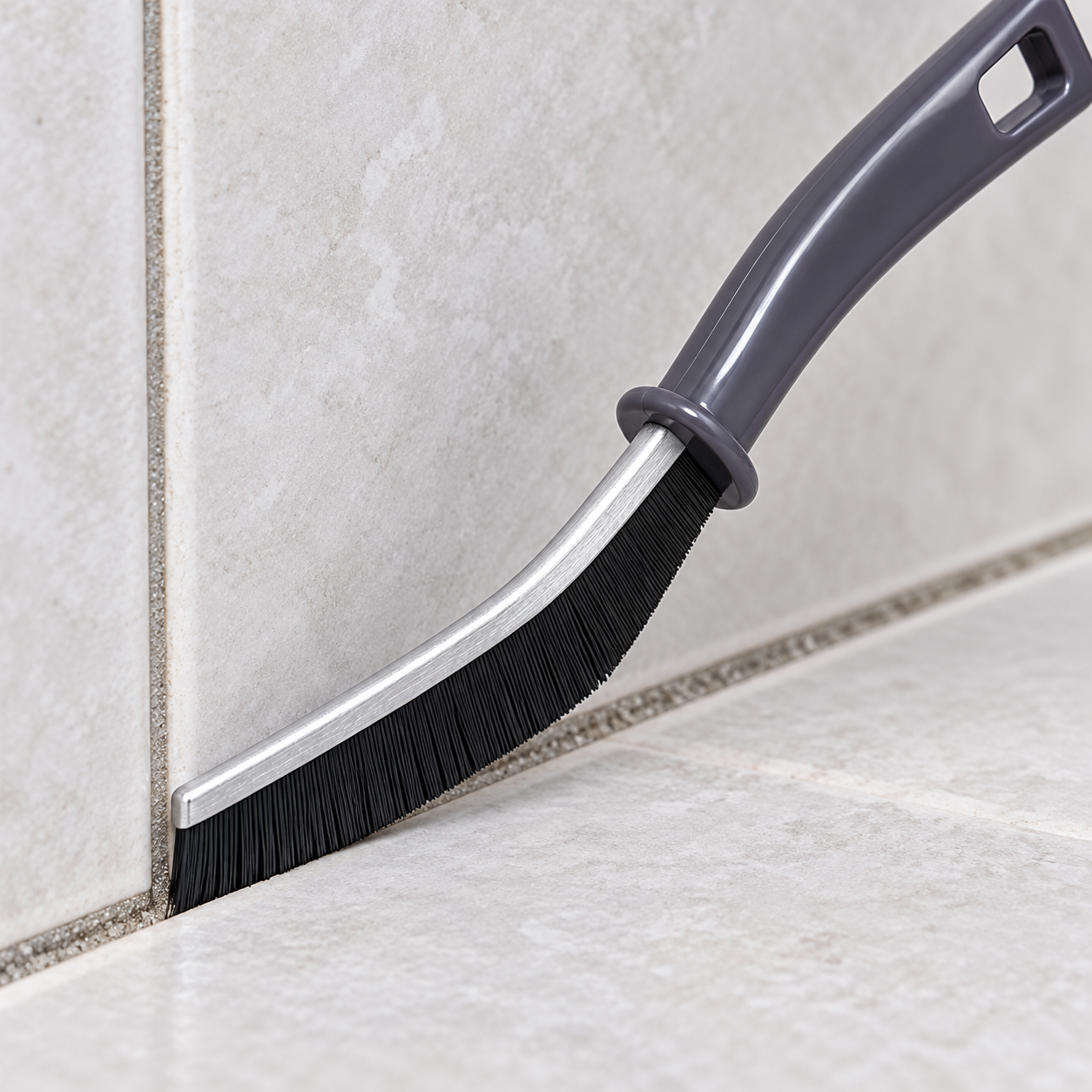 Close-up of the grout brush bristles and curved rail