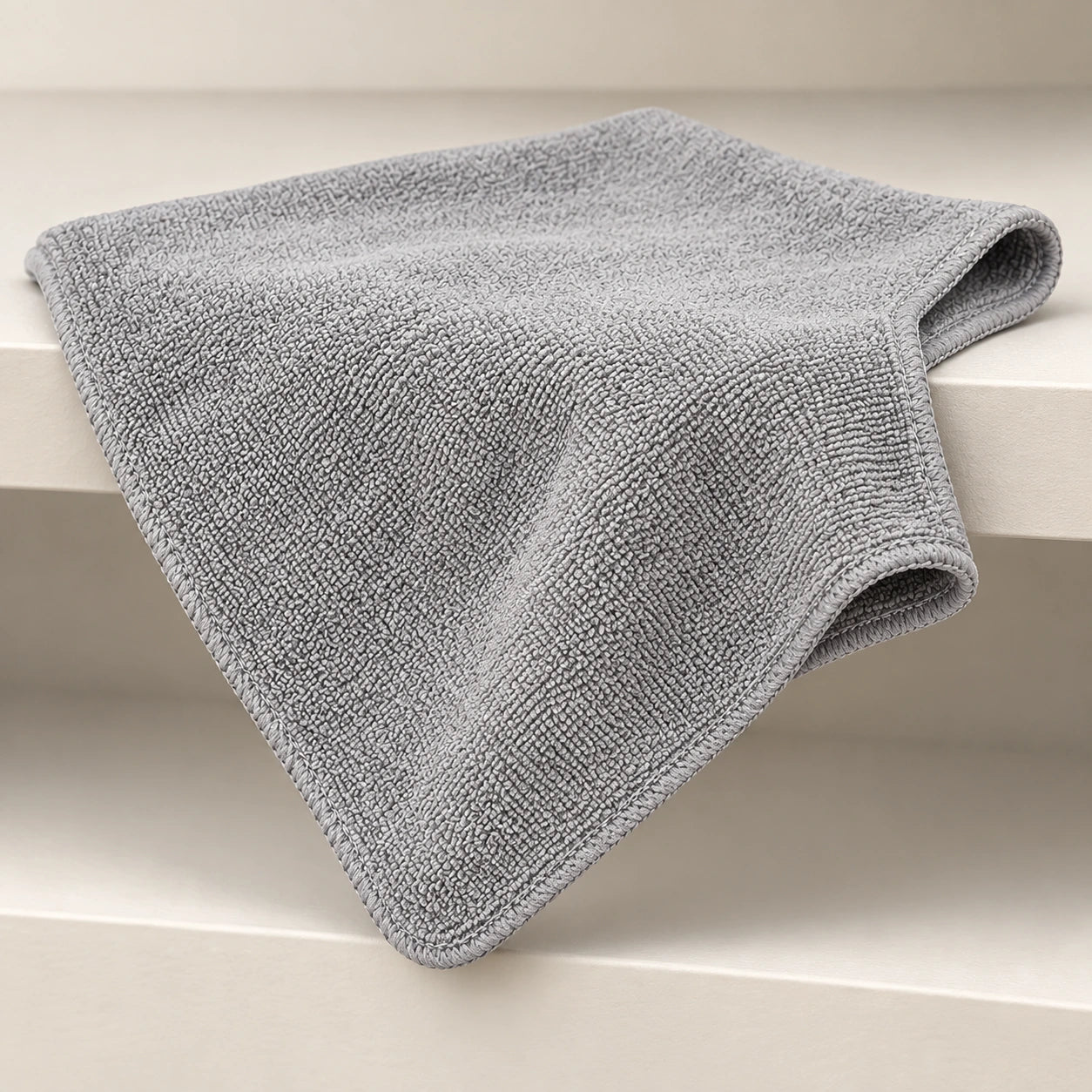 Flexible grey cloth draped over a shelf edge