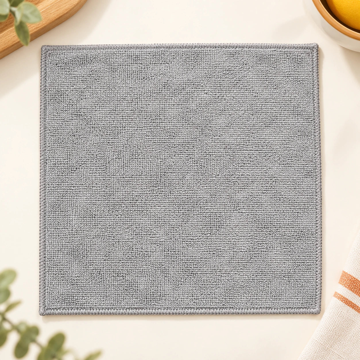 One grey square cleaning cloth laid flat